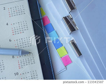 Documents, calendar, notebook, and sticky notes on the table Documents, calendar, notebook, and sticky notes on the table 113341587