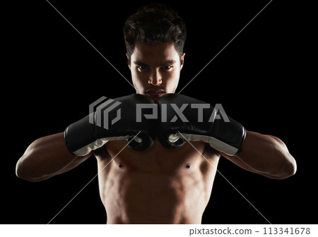 Portrait, man and boxer in stance for training, sports or workout for body health isolated on black background in studio. Fighter, serious face and athlete in gloves for fitness or exercise in Brazil Portrait, man and boxer in stance for training, sports or workout for body health isolated on black background in studio. Fighter, serious face and athlete in gloves for fitness or exercise in Brazil 113341678