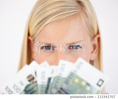 Eyes, finance and woman serious about money in studio on a white background for tax, salary or increase. Accounting, economy or payment and a young person with cash for bank savings or growth 113341707