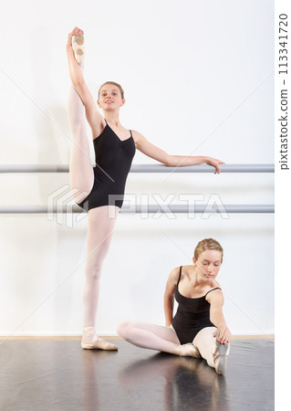 Dancing, girls and teenager in rehearsal for ballet with fitness, happy or artistic performance routine. Dance studio, friends or creative practice in preparation for entertainment, training or class 113341720