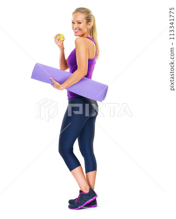 Woman, portrait and apple with yoga mat in studio, smile and pilates for fitness on white background. Female person, happy and fruit for minerals or vitamins, wellness and healthy diet for fiber 113341775
