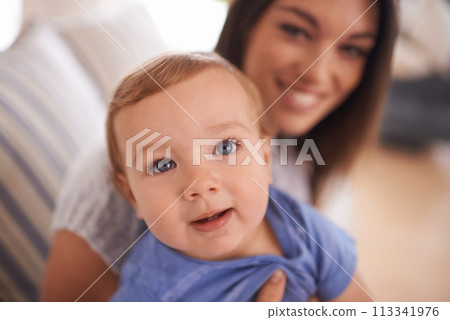 Mother, portrait or baby in home for hug, happiness and bonding in a family house in living room. Relax, boy and face of a toddler with mom, love or care for child development, wellness or growth 113341976