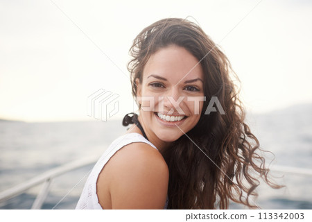 Woman, portrait and smile on yacht in outdoors, happy and travel to ocean on summer holiday. Female person, cruise and relax on boat transportation in water, peace and sailing in Italy on vacation 113342003