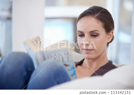 Woman, relax and reading book in home for story, novel and learning knowledge on sofa in living room. Lady, fiction books and break to enjoy literature, hobby and comfortable rest on couch in lounge 113342131