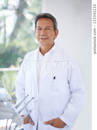 Senior dentist, man in portrait and dental for teeth whitening and orthodontics with oral health at practice or clinic. Healthcare, medical professional and expert orthodontist with service for mouth 113342210