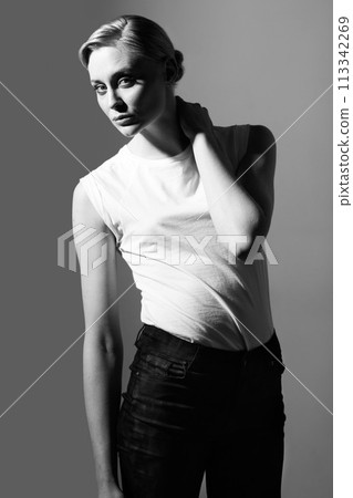 Woman, black and white in studio for vintage fashion or classic aesthetic by gray background with light. Isolated model, edgy outfit or clothes with retro style, lady or pose with art deco in studio Woman, black and white in studio for vintage fashion or classic aesthetic by gray background with light. Isolated model, edgy outfit or clothes with retro style, lady or pose with art deco in studio 113342269