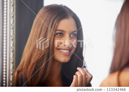 Woman, smile and lip gloss in mirror for makeup, application and getting ready with reflection in bedroom. Girl, shine and person with happiness for cosmetics, self care and beauty product in home Woman, smile and lip gloss in mirror for makeup, application and getting ready with reflection in bedroom. Girl, shine and person with happiness for cosmetics, self care and beauty product in home 113342466