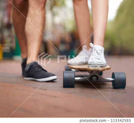 Skateboard, learning and legs of couple of friends teaching partner skills, riding lesson or practice moving. Skate shoes, sneakers and closeup person coaching, help or support balance on ground Skateboard, learning and legs of couple of friends teaching partner skills, riding lesson or practice moving. Skate shoes, sneakers and closeup person coaching, help or support balance on ground 113342583