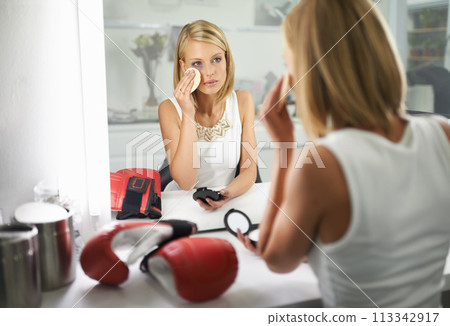 Woman, bruise and boxing gloves by mirror, makeup and stylish outfit in dressing room. Female person, blush and eyeshadow for sport match, reflection and fashion to prepare for post interview 113342917