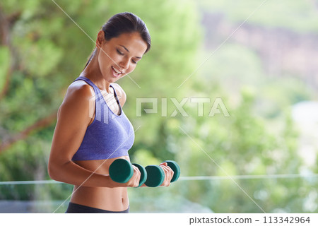 Happy woman, fitness and weightlifting with dumbbells for exercise, workout or muscle gain on balcony. Female person with smile for lifting weight or small barbells for outdoor training on terrace 113342964