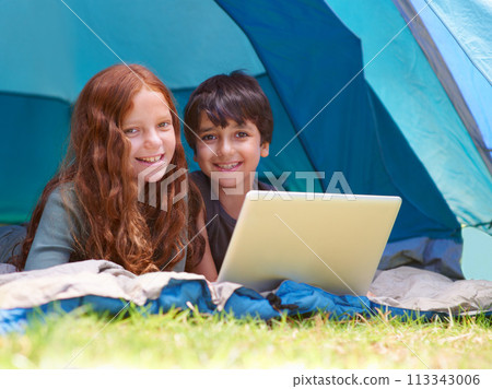 Children, portrait and happy with laptop for camping in tent, social media or online movie with vacation in nature. Family, face and siblings or smile outdoor on grass for trip, relax and holiday fun Children, portrait and happy with laptop for camping in tent, social media or online movie with vacation in nature. Family, face and siblings or smile outdoor on grass for trip, relax and holiday fun 113343006