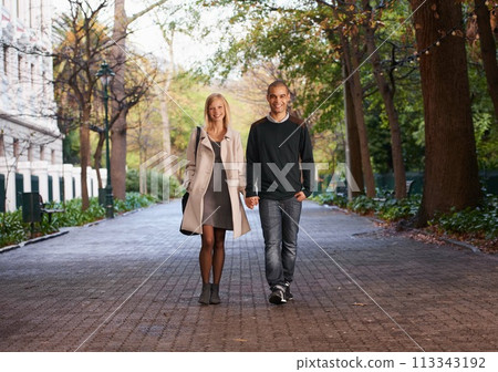 Happy, holding hands and portrait of couple in park for bonding, relationship and love outdoors. Interracial, dating and man with woman walking for fashion, care and weekend to relax together Happy, holding hands and portrait of couple in park for bonding, relationship and love outdoors. Interracial, dating and man with woman walking for fashion, care and weekend to relax together 113343192
