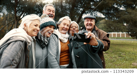 Excited, selfie and group of senior friends in outdoor green environment for fresh air. Diversity, happy and elderly people in retirement taking picture together while exploring and bonding in a park 113343209