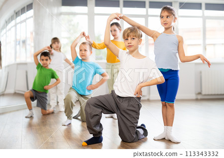 Girl paired up with boy, they train to perform slow waltz dance, rehearse performance. Girl paired up with boy, they train to perform slow waltz dance, rehearse performance. 113343332