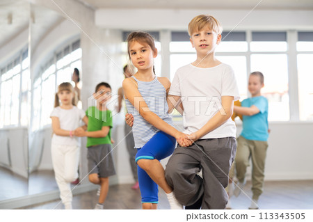 Girl paired up with boy and training to perform slow couple dance, rehearse performance. Girl paired up with boy and training to perform slow couple dance, rehearse performance. 113343505