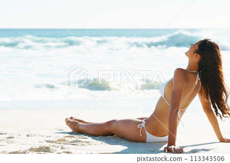 Water, relax and woman on beach with sunshine, bikini and waves on summer holiday California. Nature, sun and happy girl sitting at ocean with vacation, adventure and travel with suntan on sea sand. Water, relax and woman on beach with sunshine, bikini and waves on summer holiday California. Nature, sun and happy girl sitting at ocean with vacation, adventure and travel with suntan on sea sand. 113343506