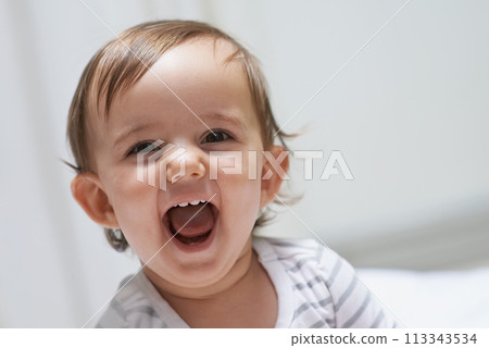 Baby girl, funny and happy for playing, child development and infant growth with face, sitting and home. Laugh, joyful and healthy in good mood, childhood or cheerful with enthusiasm, kid or adorable 113343534