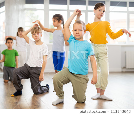 Girl paired up with boy, they train to perform slow waltz dance, rehearse performance. Girl paired up with boy, they train to perform slow waltz dance, rehearse performance. 113343643