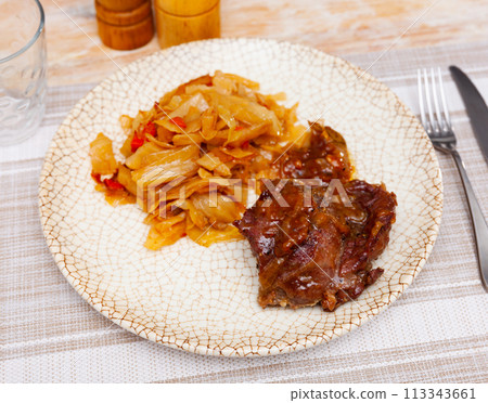 Tasty meat pork served with braised cabbage on served table 113343661