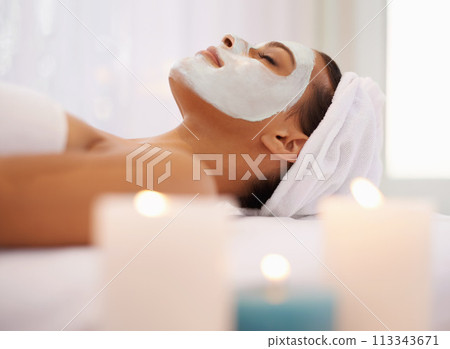 Woman, face mask and candles for wellness in spa, detox and facial treatment with cosmetic product. Person, relax and dermatology with natural clay moisture on skin, calm and zen in spa for health Woman, face mask and candles for wellness in spa, detox and facial treatment with cosmetic product. Person, relax and dermatology with natural clay moisture on skin, calm and zen in spa for health 113343671