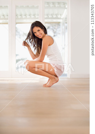 Morning, space and portrait of happy woman in house for resting in bedroom pajamas to relax alone. Floor mockup, peace or female person on break with smile or squat ready to start day for wellness 113343705