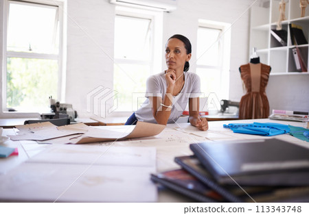 Tailor, thinking and woman planning for fashion with ideas and brainstorming in workshop. Creative, designer or person with inspiration in notebook on desk for unique style in boutique studio Tailor, thinking and woman planning for fashion with ideas and brainstorming in workshop. Creative, designer or person with inspiration in notebook on desk for unique style in boutique studio 113343748