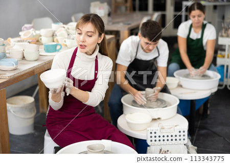 Young woman holding crafted clay cup Young woman holding crafted clay cup 113343775