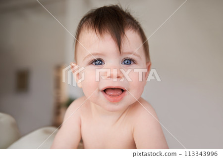 Happy, cute and portrait of baby in nursery playing for child development in living room at home. Sweet, adorable and young infant, toddler or kid learning sitting in bedroom in modern house. 113343996