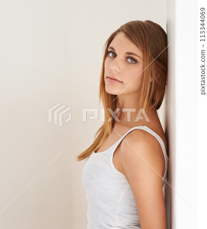 Beauty, portrait and woman leaning on wall with natural makeup in white background of studio. Serious, model and glow on skin from cosmetics and skincare aesthetic with calm, confidence and pride Beauty, portrait and woman leaning on wall with natural makeup in white background of studio. Serious, model and glow on skin from cosmetics and skincare aesthetic with calm, confidence and pride 113344069