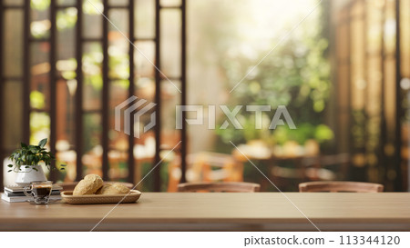 A rustic wooden tabletop, with a blurred background featuring the beautiful garden of a restaurant. A rustic wooden tabletop, with a blurred background featuring the beautiful garden of a restaurant. 113344120