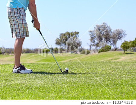Man, golf club and ball on green grass, field or lawn for sports, shot or ready to strike on course. Closeup of male person, golfer or player legs in stance with stick for score or point in nature Man, golf club and ball on green grass, field or lawn for sports, shot or ready to strike on course. Closeup of male person, golfer or player legs in stance with stick for score or point in nature 113344138