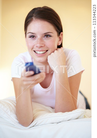 Bedroom, watching tv and woman with a remote, relax and happiness with weekend break, cheerful and resting. Person, home and girl with a channel, television and series with movie, show and peaceful Bedroom, watching tv and woman with a remote, relax and happiness with weekend break, cheerful and resting. Person, home and girl with a channel, television and series with movie, show and peaceful 113344223