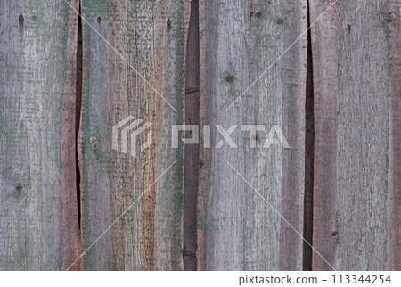 Old wooden fence with peeling paint 113344254