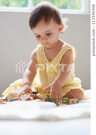 Baby, girl and toddler, toy blocks for learning and playing at home for education with alphabet. Growth, early childhood development and young kid with educational activity, game and montessori Baby, girl and toddler, toy blocks for learning and playing at home for education with alphabet. Growth, early childhood development and young kid with educational activity, game and montessori 113344308