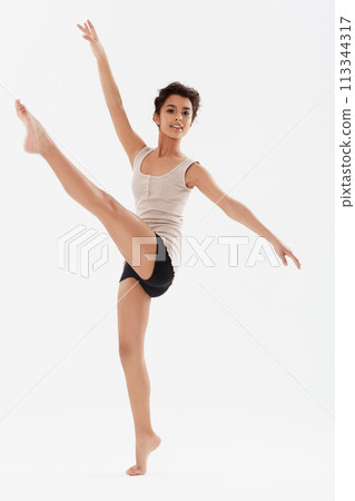 Dance, ballet and portrait of girl in studio for performance, fitness and training for theatre. Ballerina, young dancer and isolated person for balance, routine and practice on white background 113344317