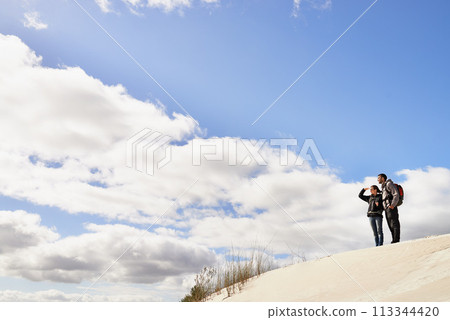 Travel, love and couple in desert for location search, view or scenery while bonding in nature. Freedom, adventure or people in sand dunes for journey, hiking or wellness, backpacking or fun in Egypt Travel, love and couple in desert for location search, view or scenery while bonding in nature. Freedom, adventure or people in sand dunes for journey, hiking or wellness, backpacking or fun in Egypt 113344420