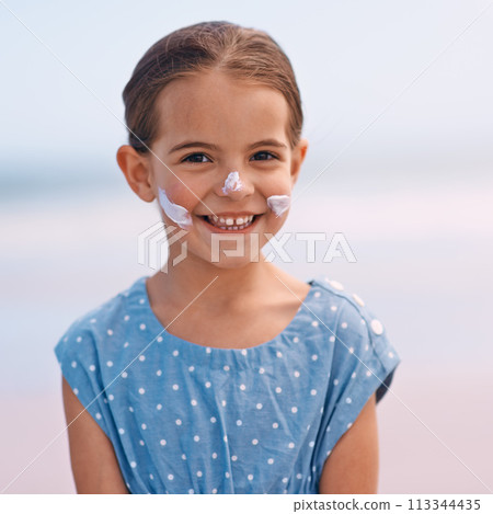 Little girl, portrait and outdoors with sunscreen, smile and cheerful on holiday vacation. Young daughter, happy and cute confidence for getaway, fun and sunblock for protection and summertime 113344435