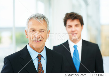 Mature, businessman and professional portrait in company with boss of team in London. Happy, manager and man in lobby with leadership, pride and confidence in business with person on staff in office 113344619