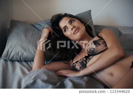 Sexy woman, thinking and bed with lingerie in fashion for seduction, pleasure or erotic clothing at home. Attractive, gorgeous or seductive female person or model lying with underwear in bedroom Sexy woman, thinking and bed with lingerie in fashion for seduction, pleasure or erotic clothing at home. Attractive, gorgeous or seductive female person or model lying with underwear in bedroom 113344620