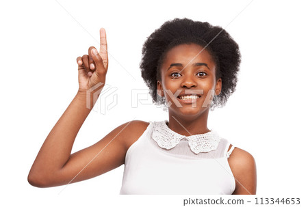 Smile, pointing and portrait of black girl in studio with mockup space for marketing or advertising. Happy, sale and young African child with positive face expression isolated by white background. 113344653