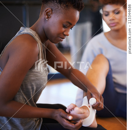 Fitness, injury and woman with ankle pain, bandage or help from personal trainer, care or first aid for anatomy risk at gym. Exercise, accident and women with foot wrap for workout, safety or healing Fitness, injury and woman with ankle pain, bandage or help from personal trainer, care or first aid for anatomy risk at gym. Exercise, accident and women with foot wrap for workout, safety or healing 113344686