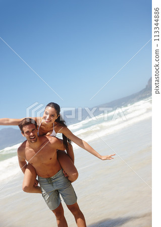 Couple, piggyback and portrait on beach with playing for bonding, summer vacation and anniversary getaway. Man, woman and love by ocean with mockup space for freedom, healthy relationship or blue sky 113344886