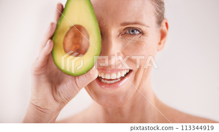 Skincare, smile and portrait of woman with avocado in studio for health, wellness or natural routine. Glow, beauty and mature person with organic fruit for dermatology treatment by white background. Skincare, smile and portrait of woman with avocado in studio for health, wellness or natural routine. Glow, beauty and mature person with organic fruit for dermatology treatment by white background. 113344919