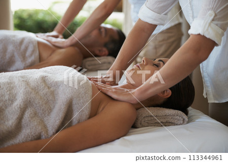 Massage, relax and couple in spa for touch, wellness and therapy on holiday or vacation for break and pamper. Young people and lay with head on towel for holistic care and peace for calm on table Massage, relax and couple in spa for touch, wellness and therapy on holiday or vacation for break and pamper. Young people and lay with head on towel for holistic care and peace for calm on table 113344961