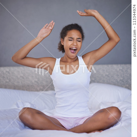 Woman, bed and stretch with yawn for morning awake on Sunday for relax weekend in apartment, day off or bedding. Female person, arms and resting in home or vacation nap or comfortable, break or tired 113344974