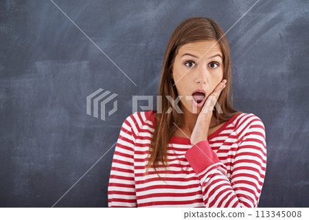 Woman, teacher and shock in portrait by blackboard, wow and what for announcement on curriculum. Female person, surprise and information in classroom, knowledge and mind blown for lesson plan at work 113345008