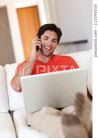 Man, talking or phone call in living room with laptop for business, entertainment or work from home. Person, notebook and mobile happy for communication, deal or conversation with network provider 113345019