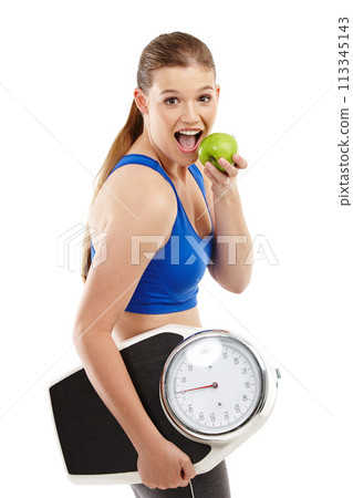 Portrait of woman, apple and scale in studio background for measurement, smile and excited for results of diet. Female person, body and care for calories target, weight loss and fruit to detox Portrait of woman, apple and scale in studio background for measurement, smile and excited for results of diet. Female person, body and care for calories target, weight loss and fruit to detox 113345143