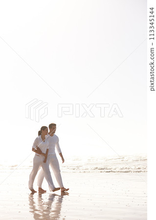 Couple, walking and beach with hug for love, embrace or valentines day in outdoor nature. Man and woman enjoying stroll by the ocean coast or sea for holiday, date or weekend together on mockup space 113345144