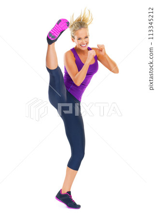 Woman, kick and portrait for exercise, fitness and diet for strength and health for wellness and cardio on white background. Model or young person with smile for gym and strong for workout in studio 113345212